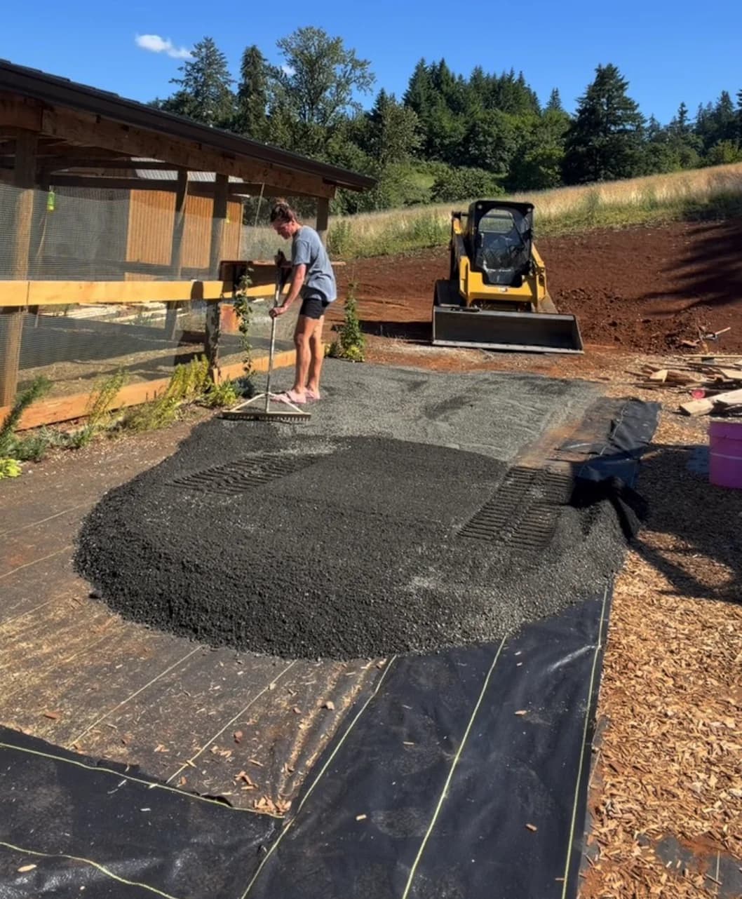 Gravel pad spread and raked over DOTDAY XBAR 5 oz dual-layer fabric beside a chicken coop
