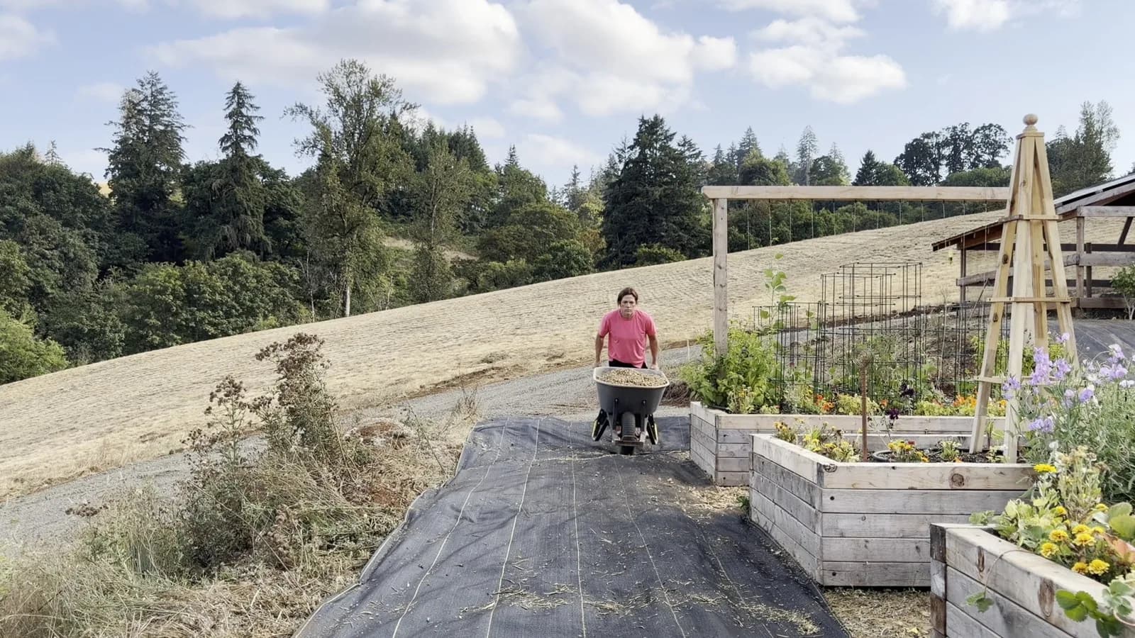 Working forward from the covered side, gravel goes down over DOTDAY XBAR on a garden path