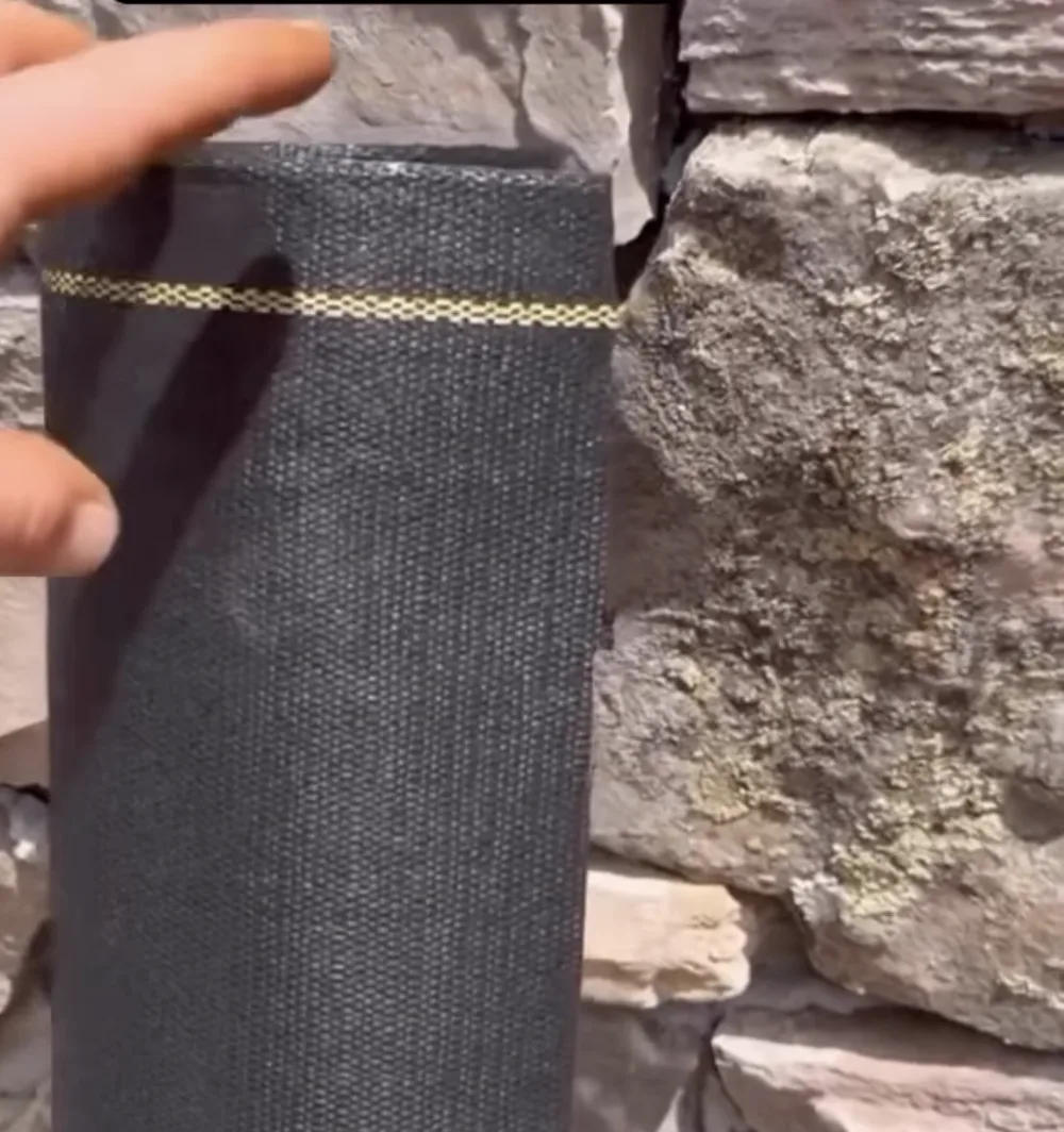 XBAR roll standing against a stone wall