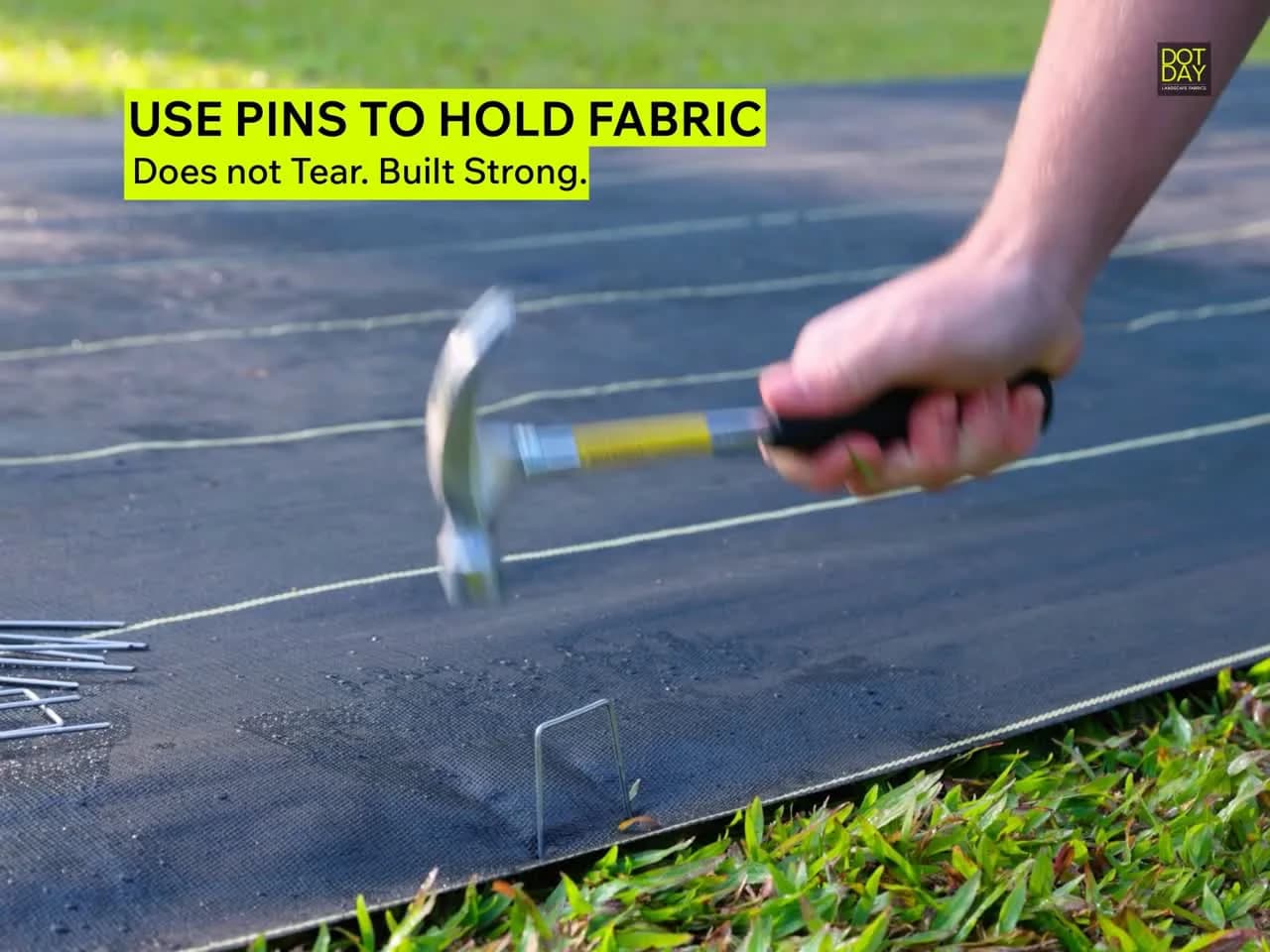 Driving landscape pins through SHIELD fabric with a hammer