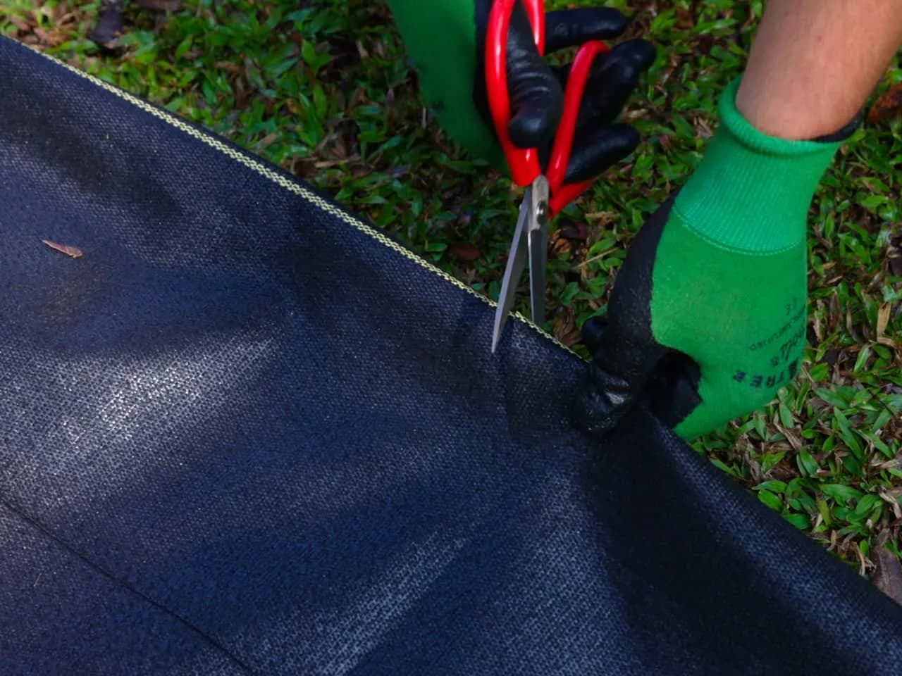 Gloved hands cutting XBAR fabric with shears