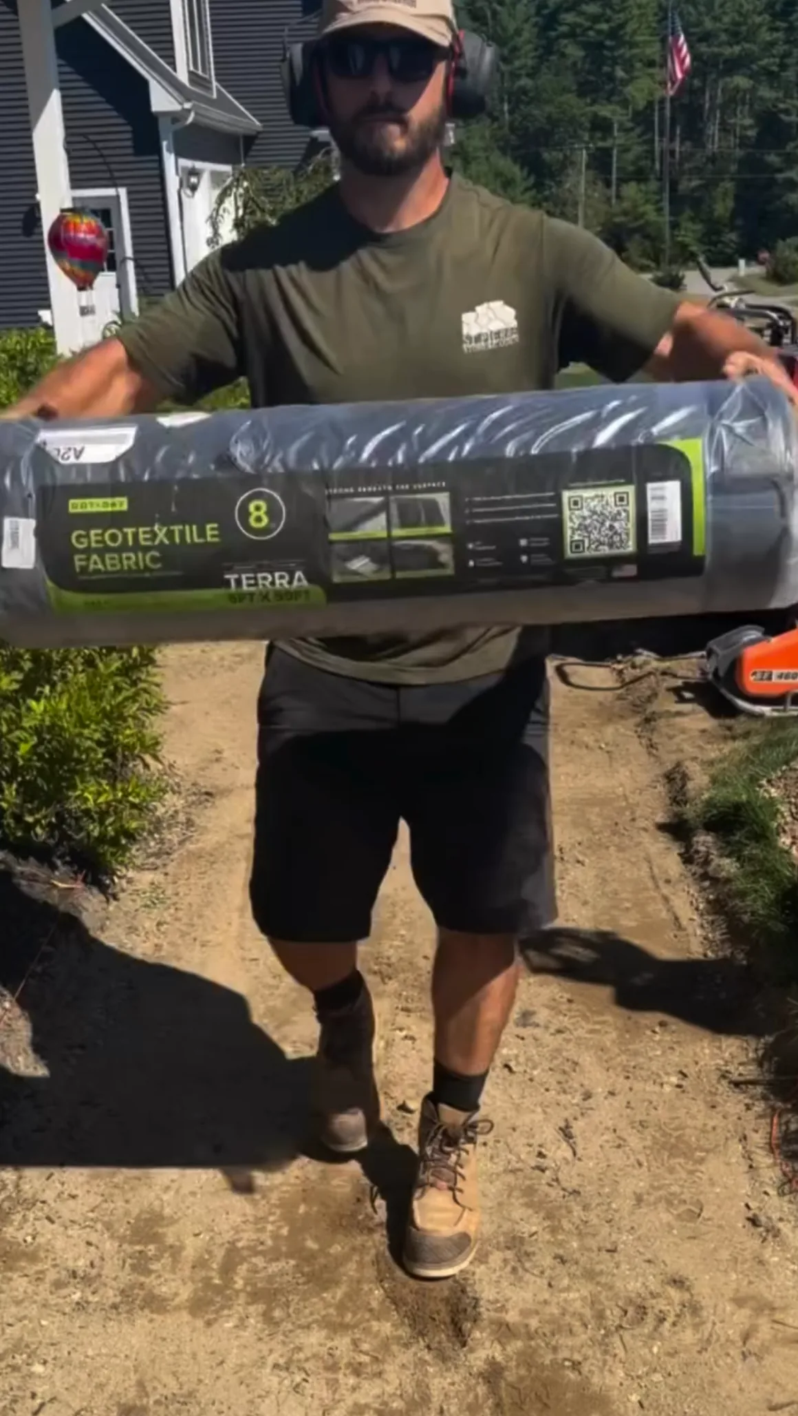 Jeff holding the packaged DOTDAY TERRA 8oz geotextile fabric roll on the walkway job