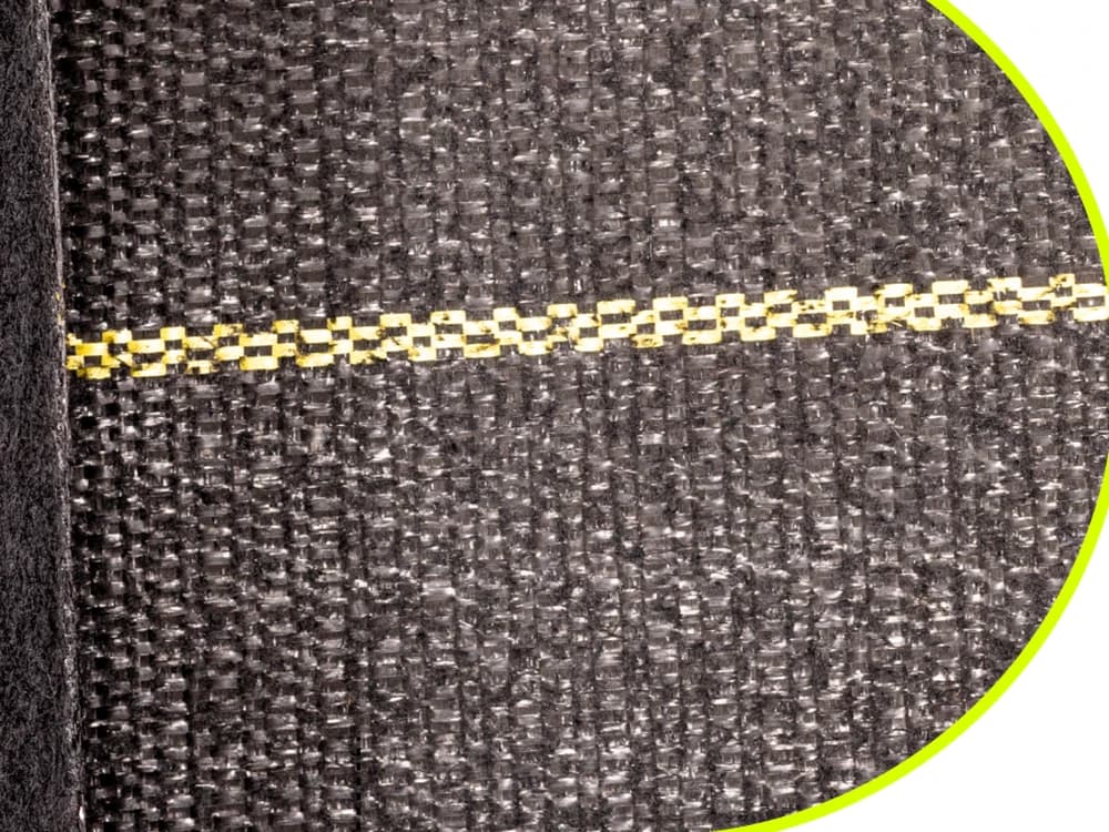 Close-up of the woven polypropylene top face of DOTDAY XBAR with the yellow 12-inch guide line