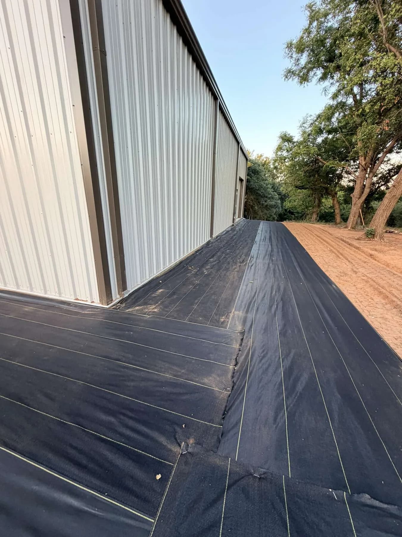 XBAR 5oz fabric runs overlapped at the corner of the metal shop with yellow guide lines visible