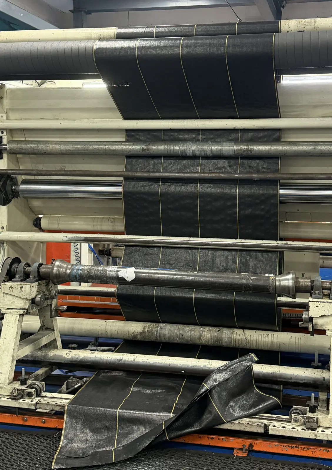 Woven landscape fabric with printed guide lines running through the rollers of our manufacturing line