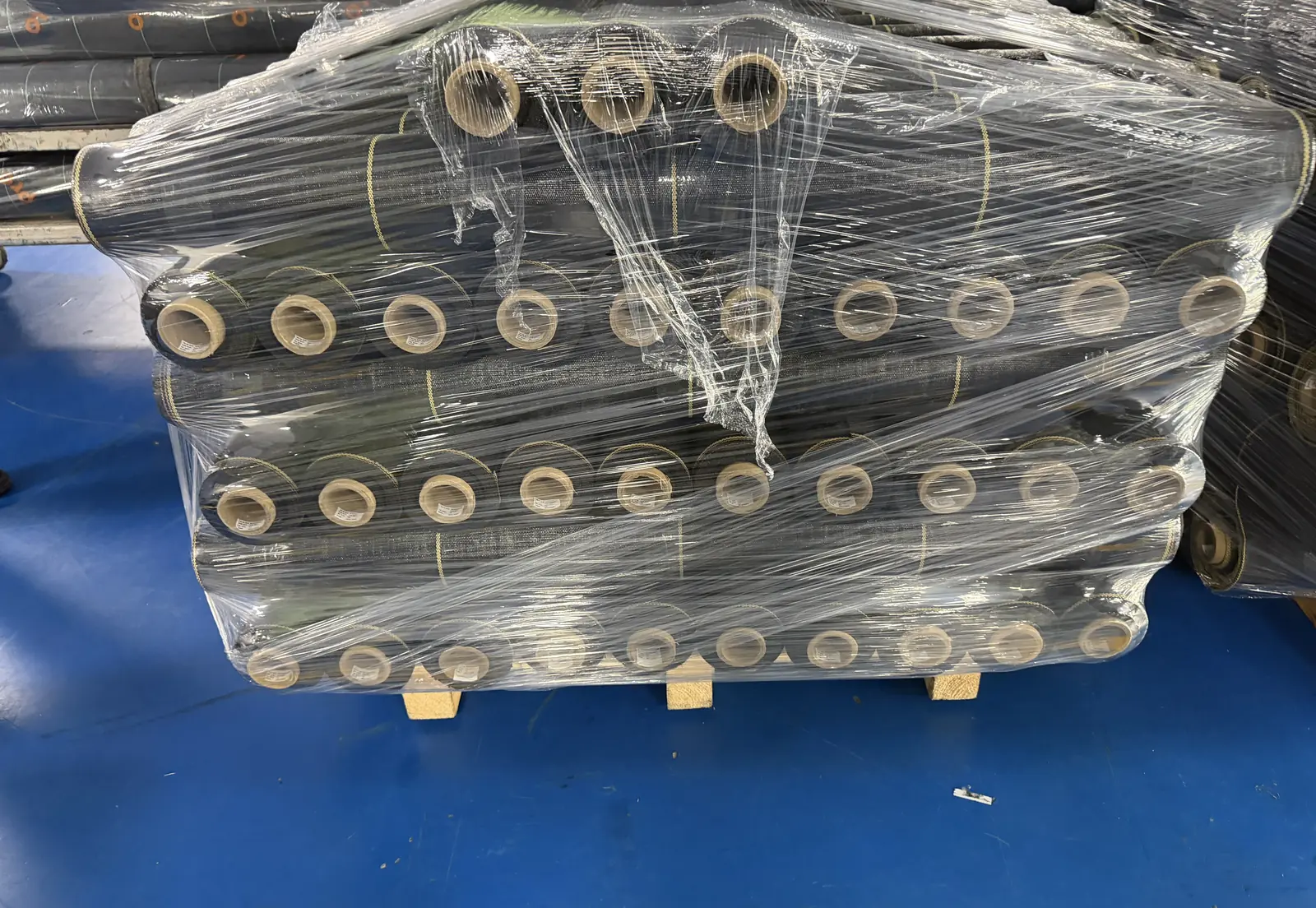 Stretch-wrapped pallet of SHIELD woven weed barrier rolls ready to ship