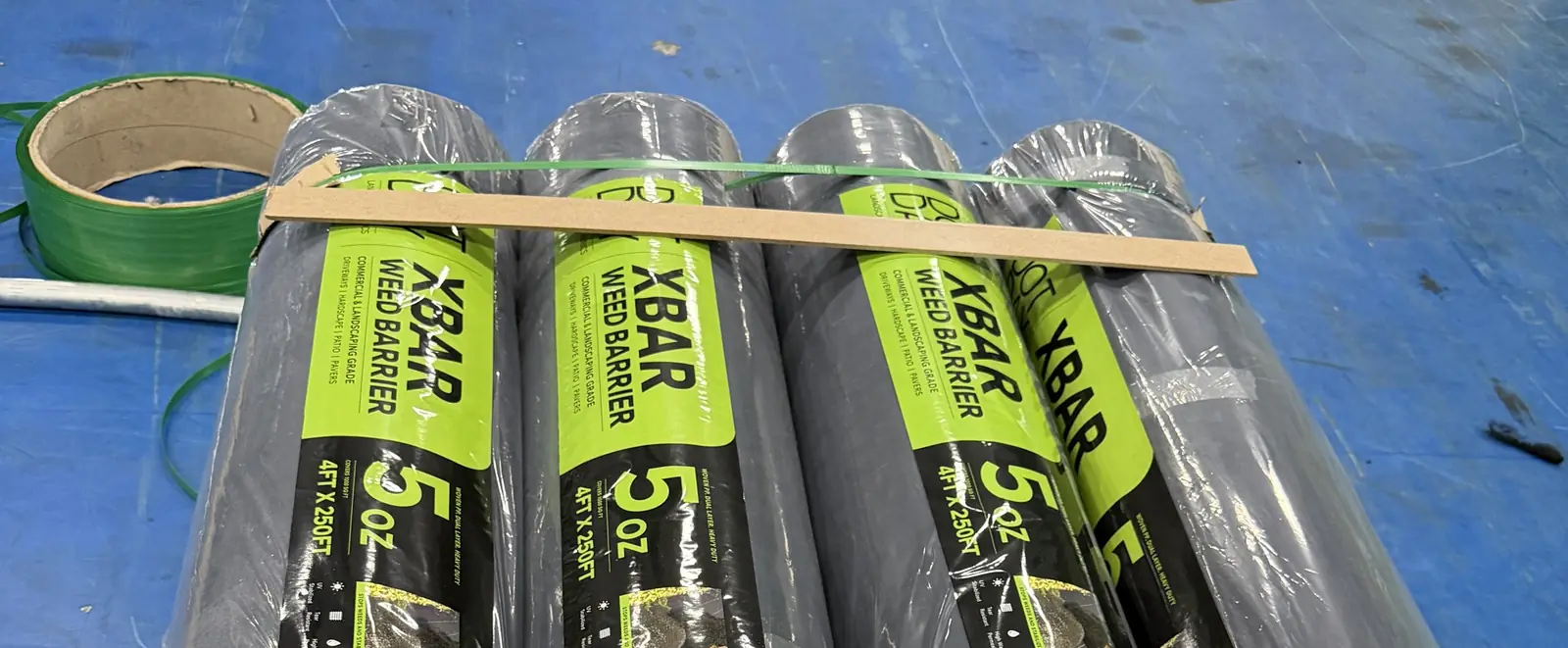 XBAR dual-layer landscape fabric rolls banded with edge boards on a pallet at our facility