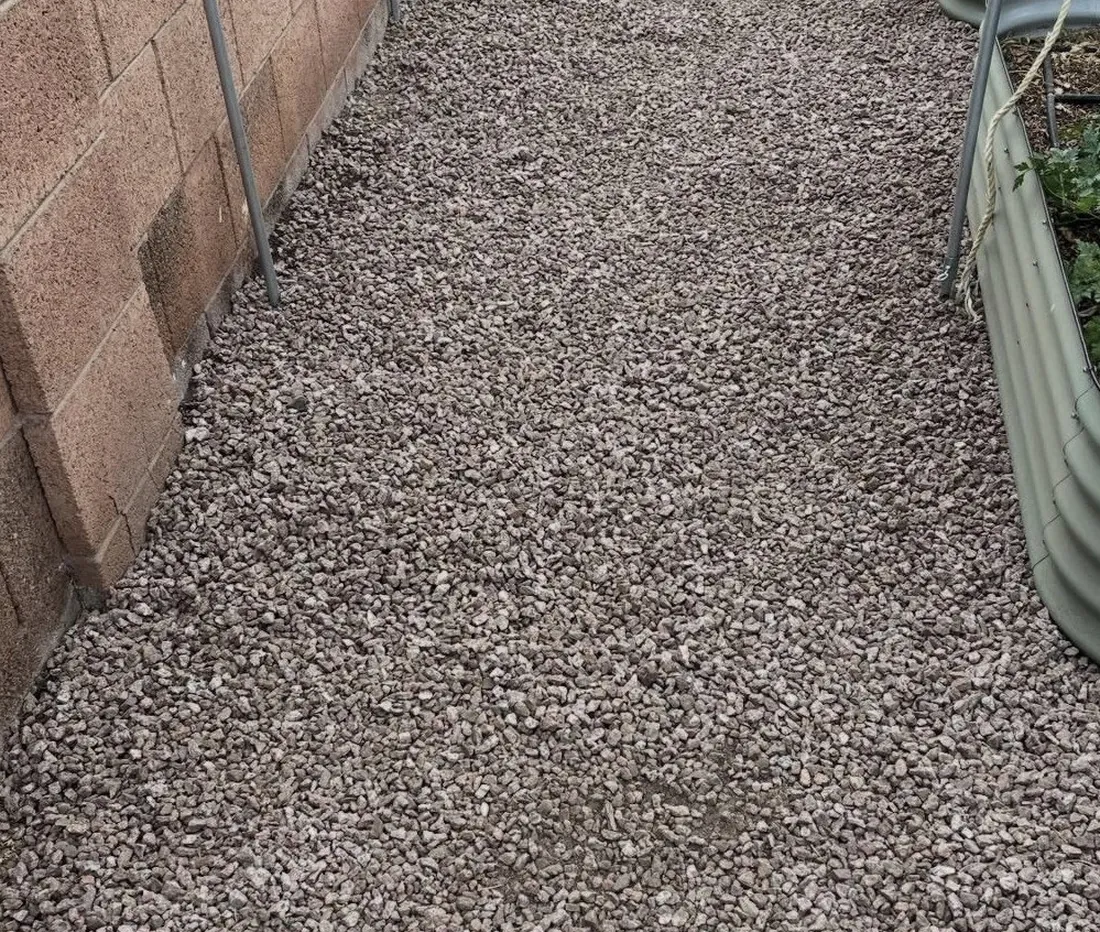 Finished gravel path laid over DOTDAY XBAR 5 oz weed barrier along a side yard